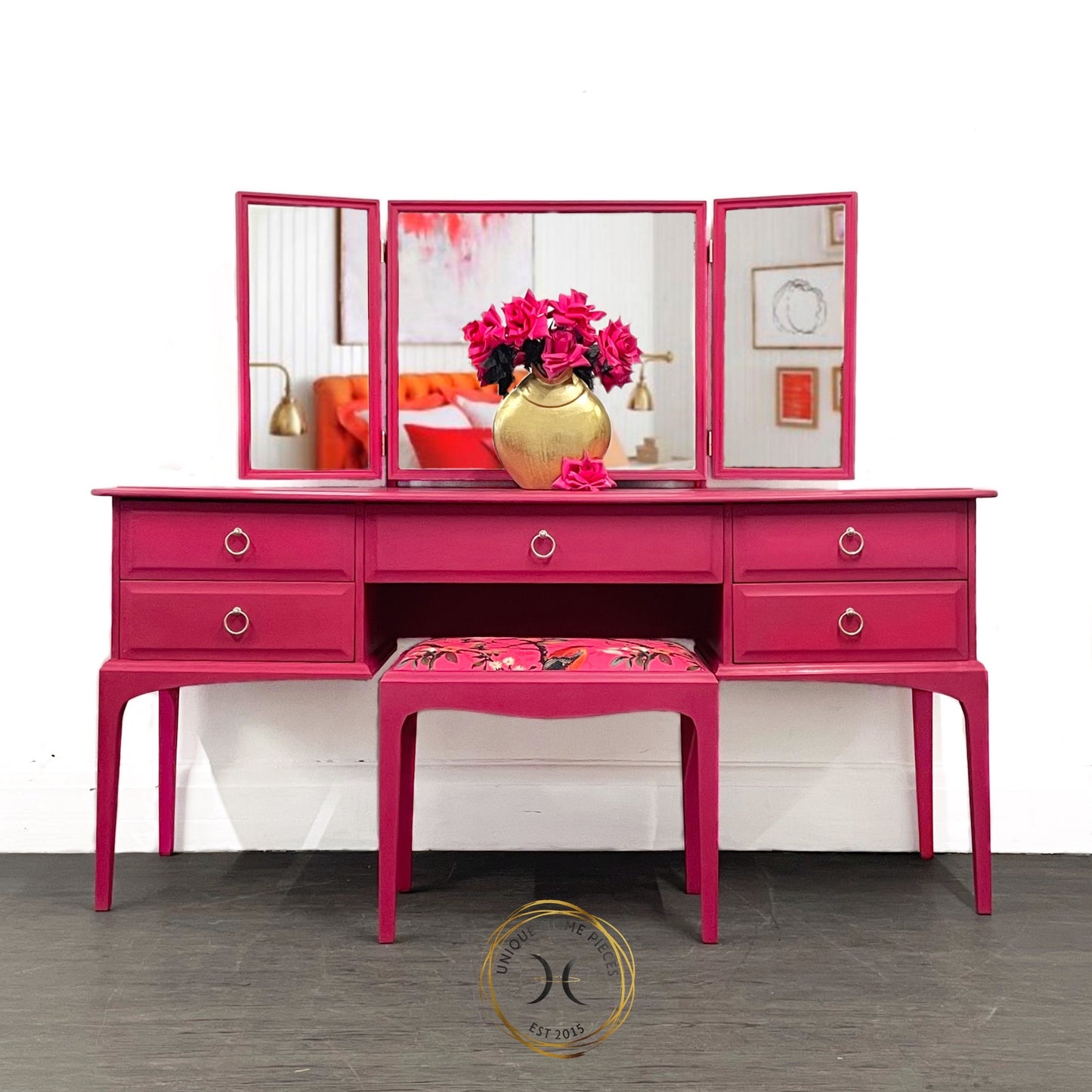 Stag 5 drawer 3 mirrored dressing table with matching stool, painted in Annie Sloan Capri Pink and waxed to seal. Stool painted the same colour the material is a velour velvet FR in hot pink with birds on branches. Handles painted in champagne gold.