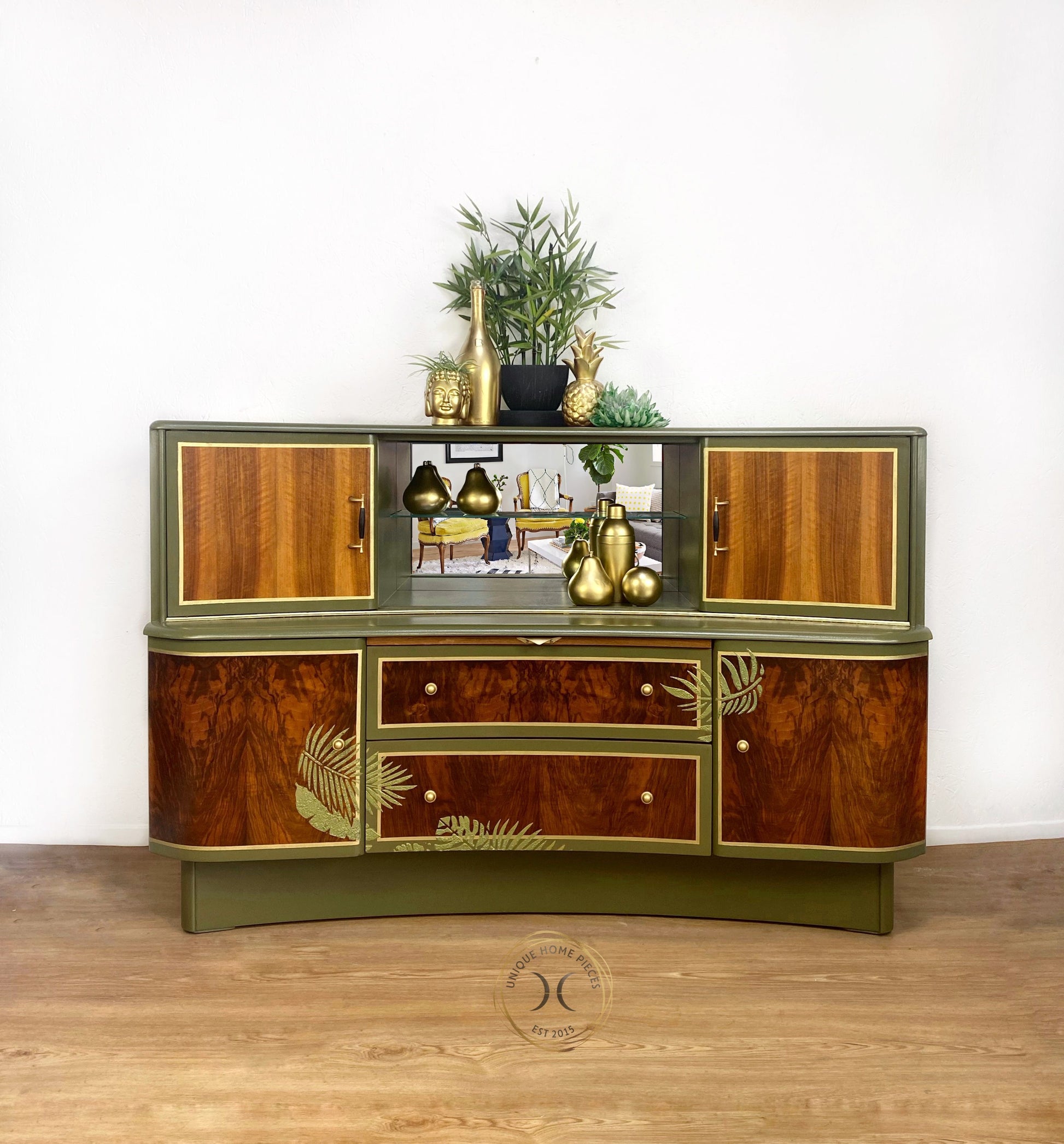consists for 4 cupboards  each sitting on the outsides with 2 central drawers at the bottom  with a pull out shelf to make your drinks on an open mirror backed display area with a glass shelf.  Teak and walnut wood  with olive green painted fern leaf design internally and externally gold stripes and hardware. varnished to seal.  H eight 92 cm Depth 50 cm Width 138  cm £2495